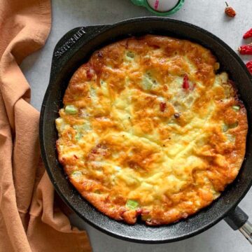 Spicy Bacon Frittata after baking in a cast iron skillet