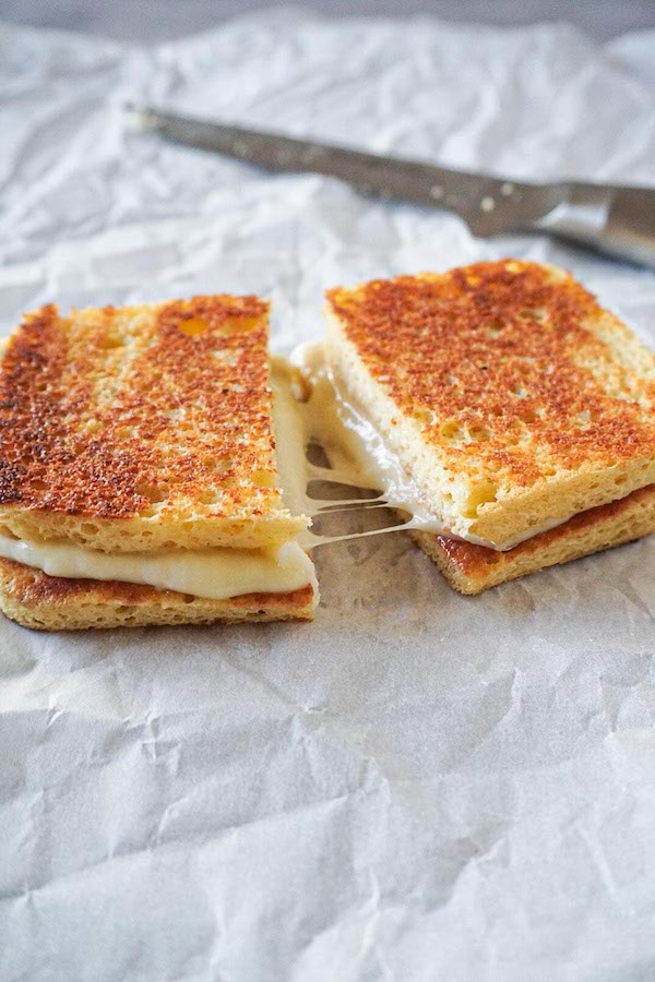 Keto grilled cheese sandwich with stringy mozzarella and gouda cheese.