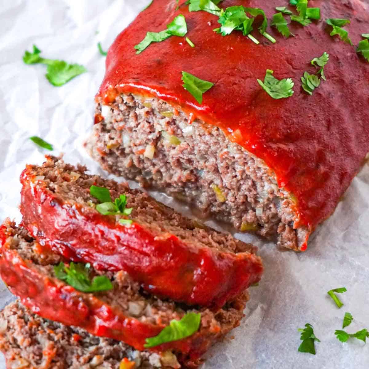 Close up picture of sliced low carb meatloaf garnished with chopped cilantro.