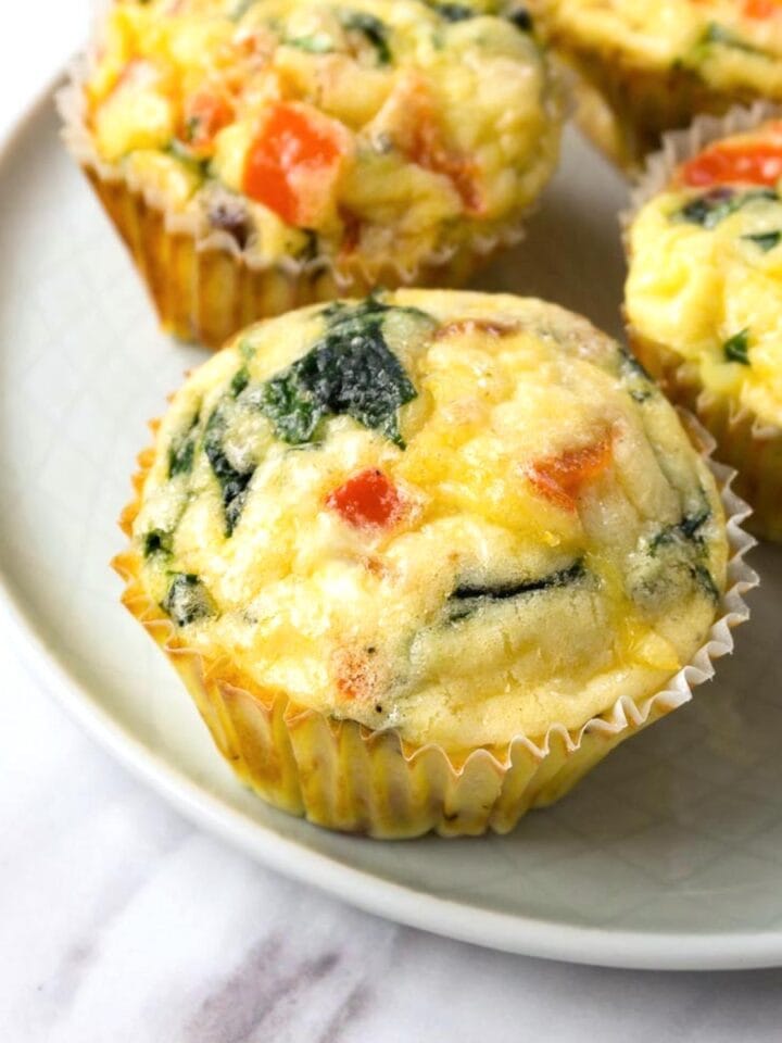 Freshly baked egg muffins on a small round plate.