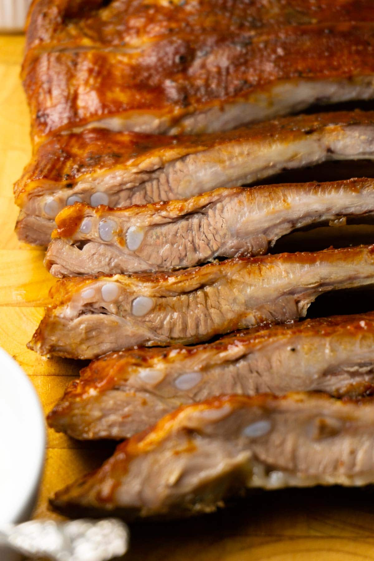 Close up shot of chopped oven-baked BBQ pork ribs.