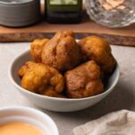 Deep-fried cauliflower bites in a serving bowl.