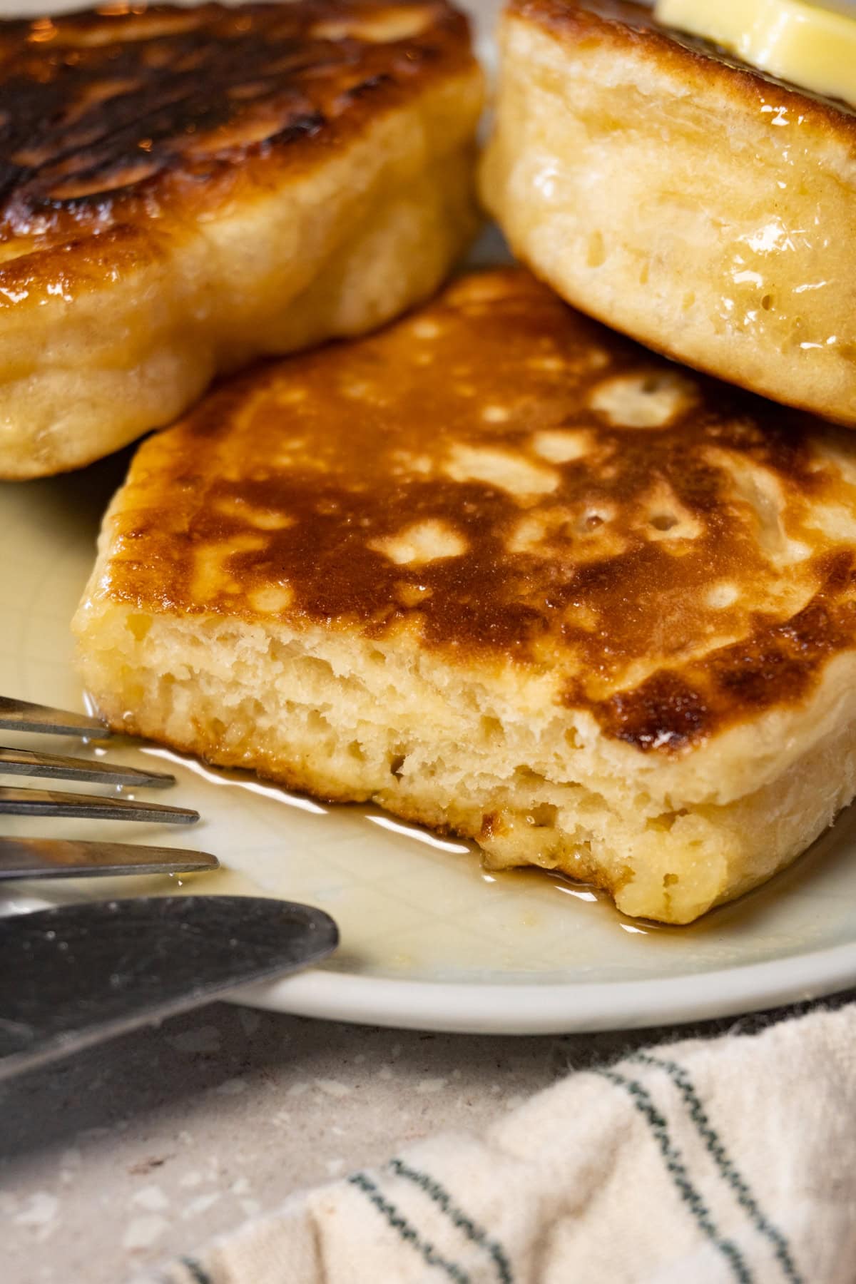 Close-up photo of pancakes, with one bite taken from one of them.
