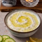 A bowl filled with tzatziki sauce.