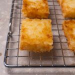 Deep-fried rice cakes on a cooling rack.