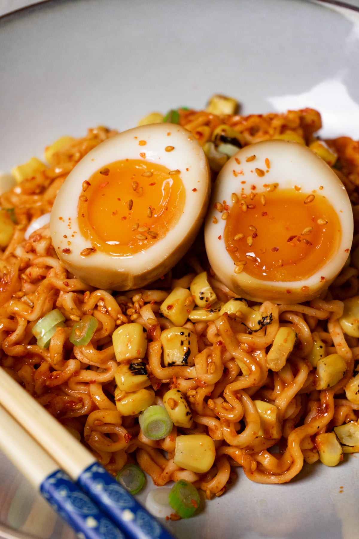 A bowl of noodles topped with jammy soy sauce eggs.