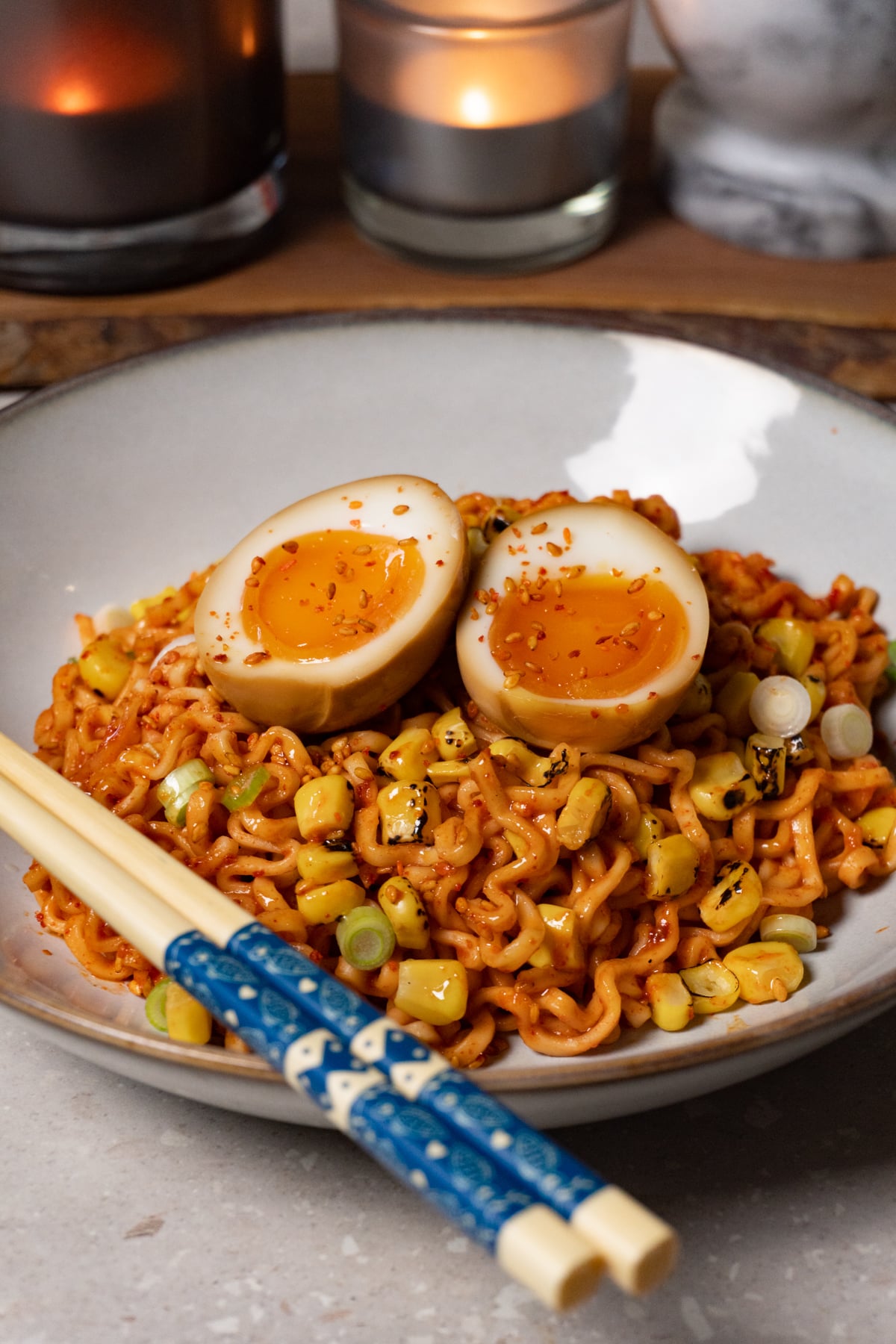 A bowl of noodles topped with jammy soy sauce eggs.