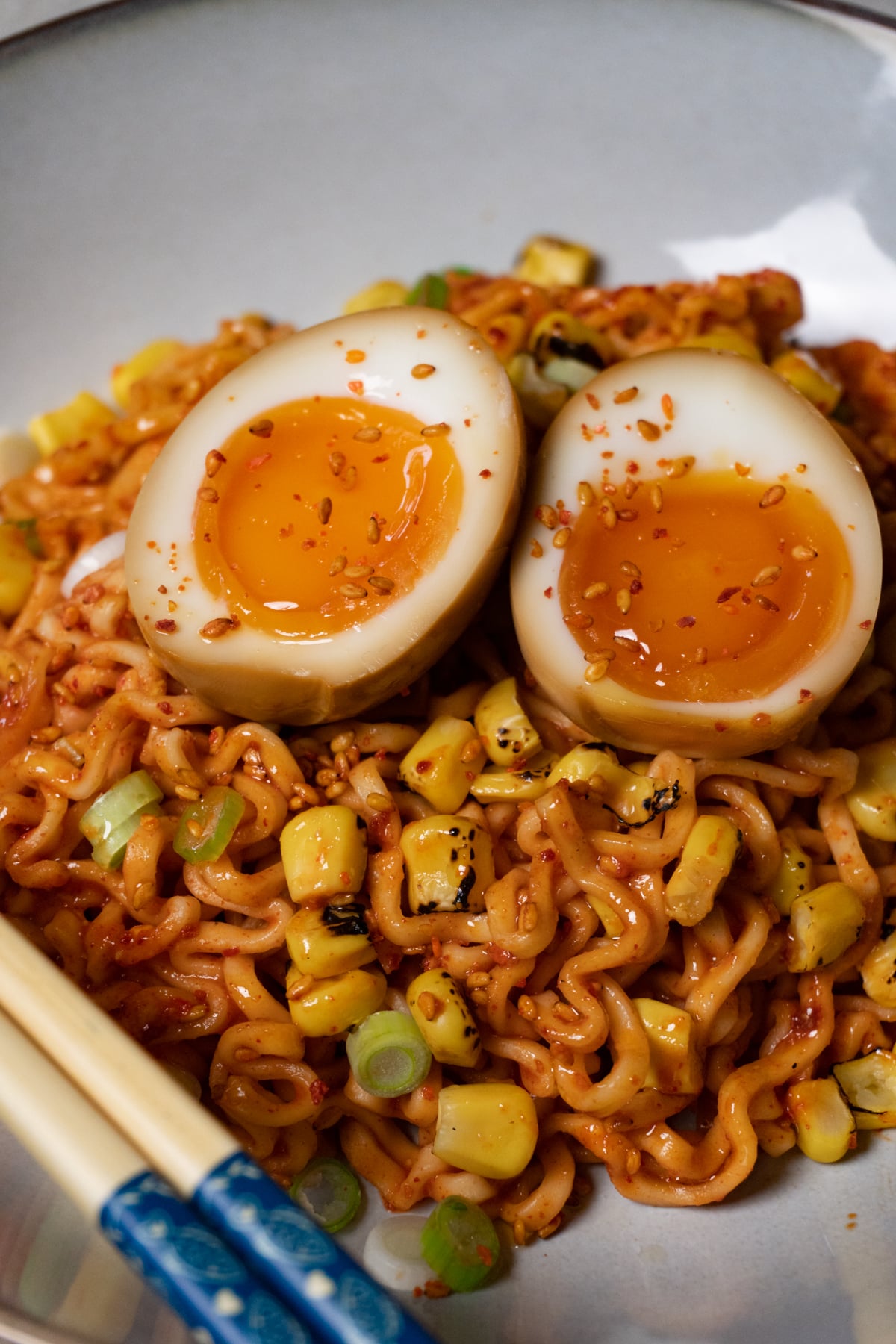 A bowl of noodles topped with jammy soy sauce eggs.