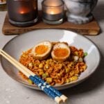 A bowl of noodles topped with jammy soy sauce eggs.